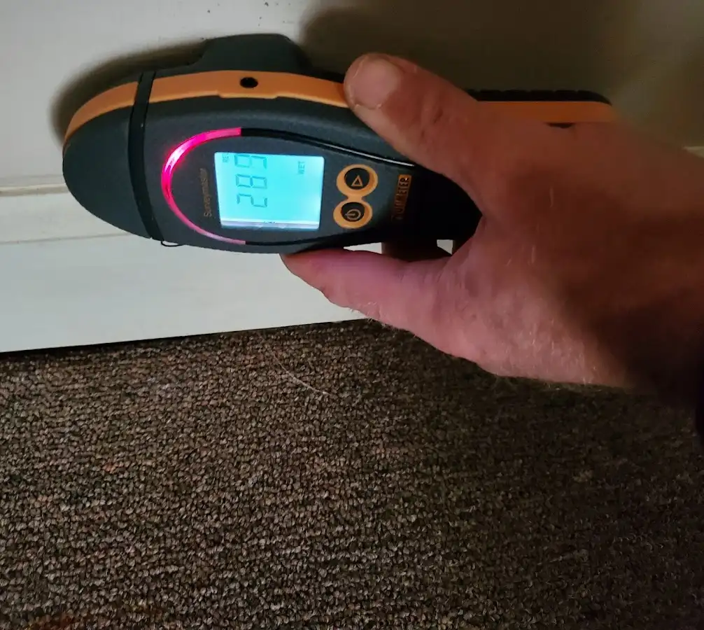 Moisture detection at baseboard during Storm Damage Restoration in Pella